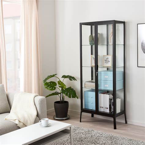 The IKEA Hemnes Glass Door Cabinet (Drawers) spots two glass doors at the top level for displaying items and three large different size drawers at the lower level for keeping fabric and books. . Display cabinet ikea